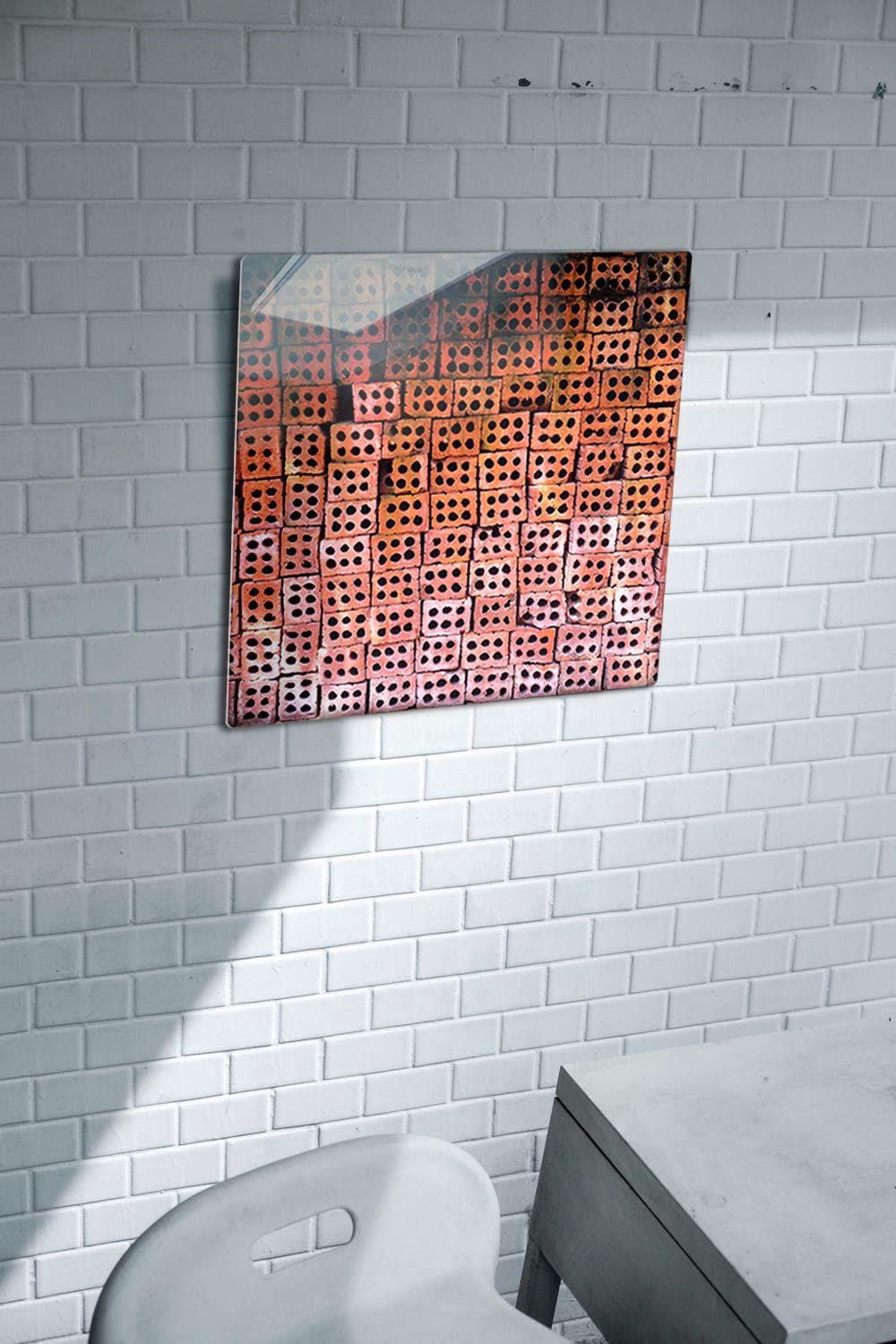 18 inch Patterns of Da Nang aluminum print on a white tiled wall above a desk and chair, with sunlight across the tiles