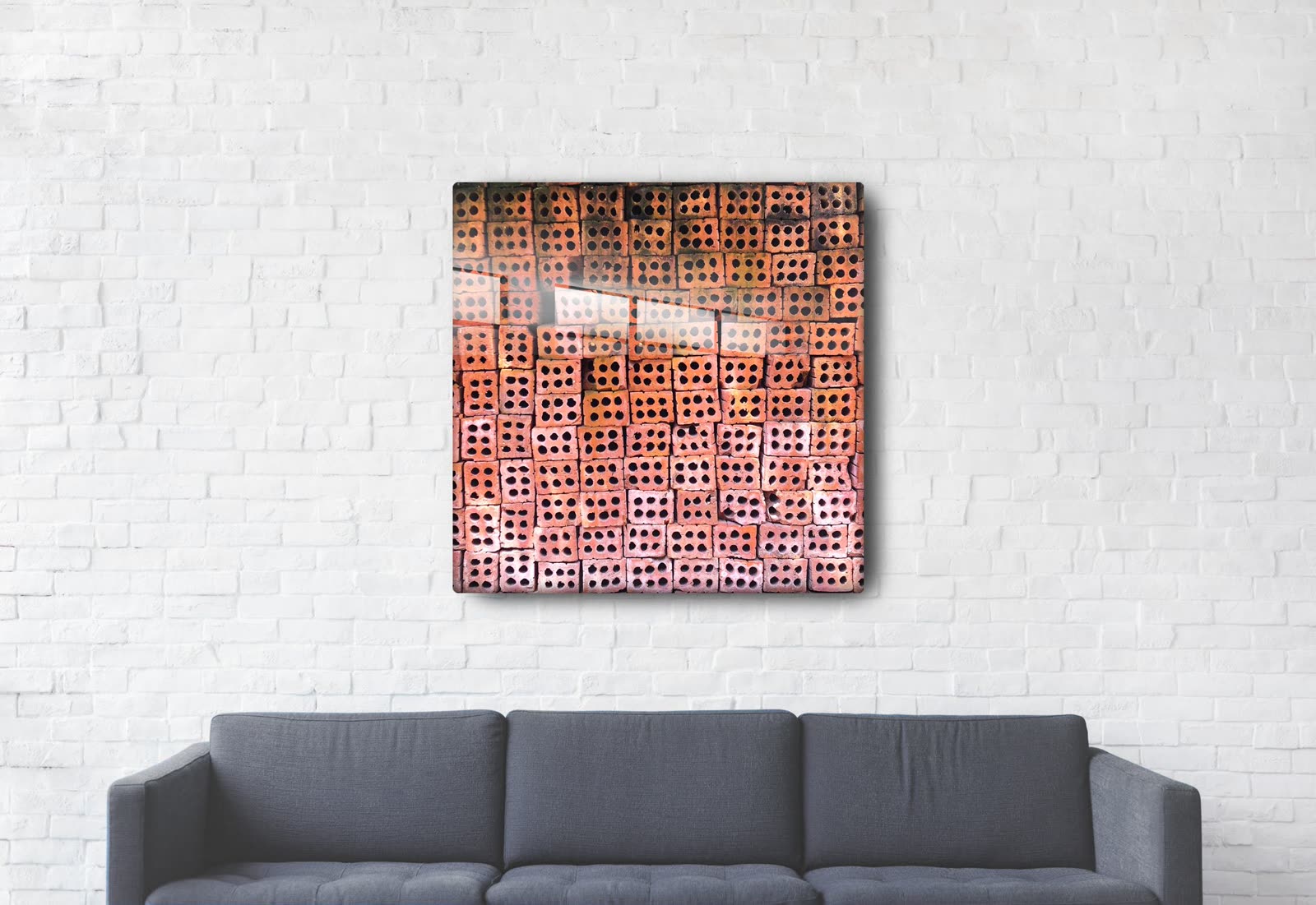 40 inch Patterns of Da Nang aluminum print mounted above a charcoal sofa on a white brick wall